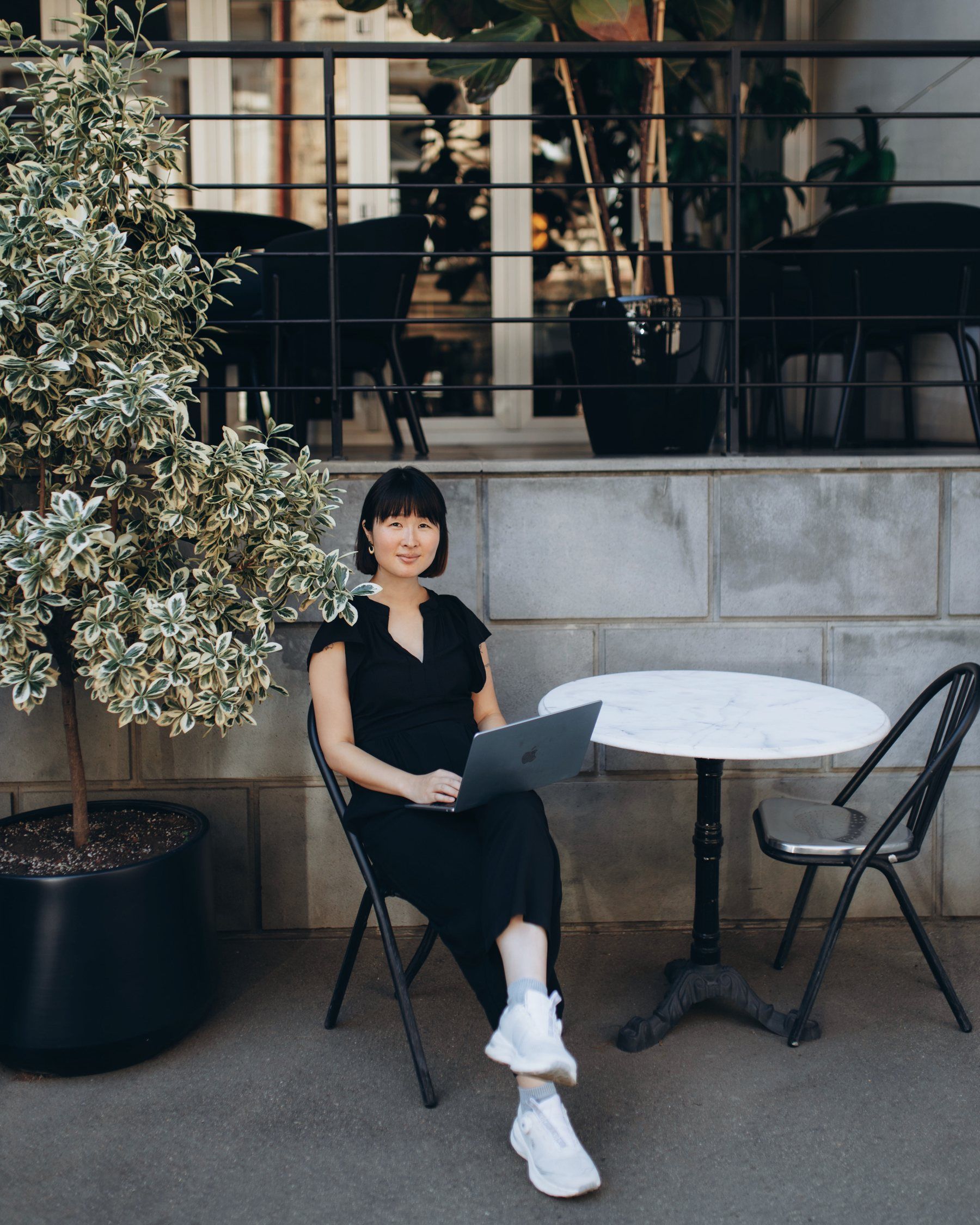 Sumire Sato writing at a desk stacked with language books