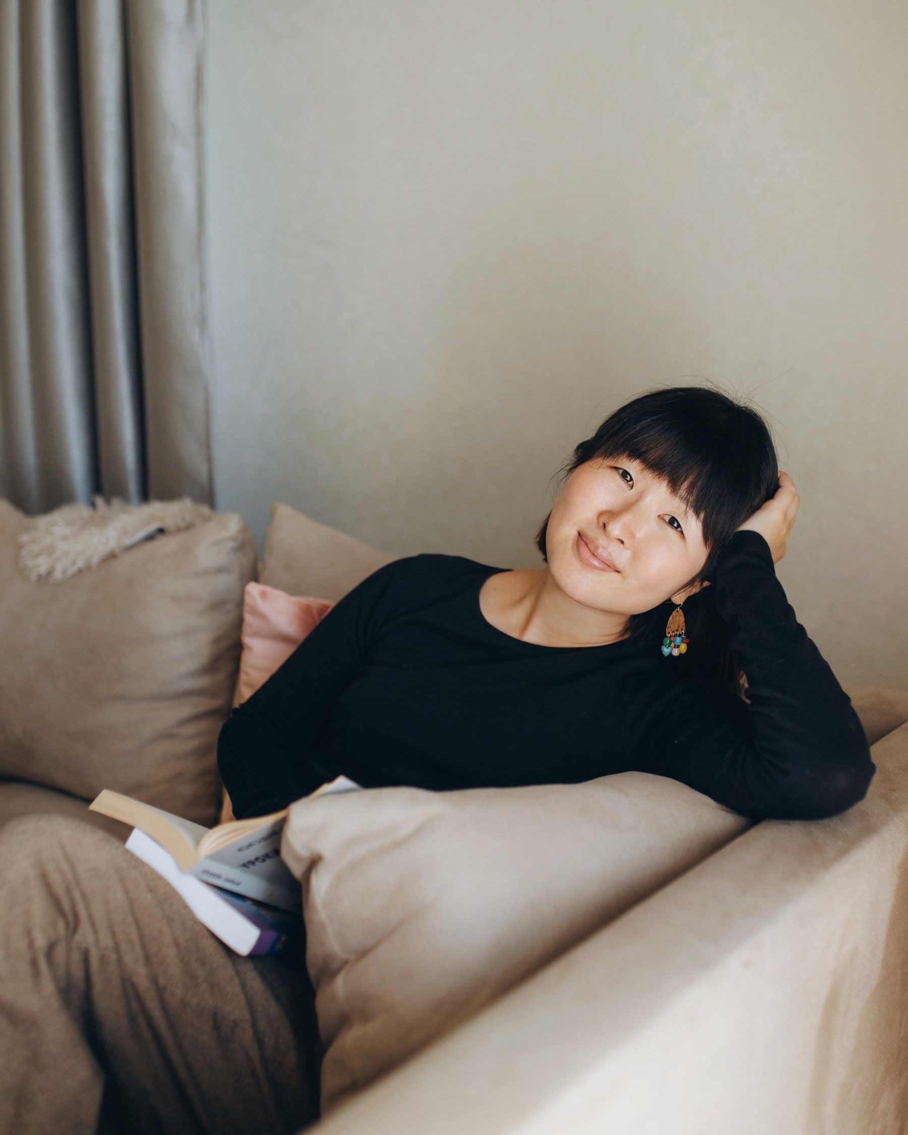 Sumire Sato at home with a book